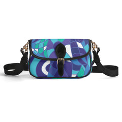 Kume Colorful geometric patterned flap bag with blue, purple, teal, and white abstract design, black trim and strap, gold hardware. Retro Chic Blissfully Brand
