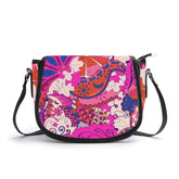 Vibrant Sameria print top-grain leather saddle bag in fuchsia, orange, and blue, with black trim and adjustable shoulder strap. Stylish women's crossbody handbag with Retro and colorful designs. Zentangle inspired. Blissfully Brand