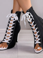 Classic Black canvas open-toe ankle boots with white sneaker-style lacing, a slender stiletto heel, and white sole accents, embodying a bold retro-funk statement - Bliss & Tell by Blissfully Brand