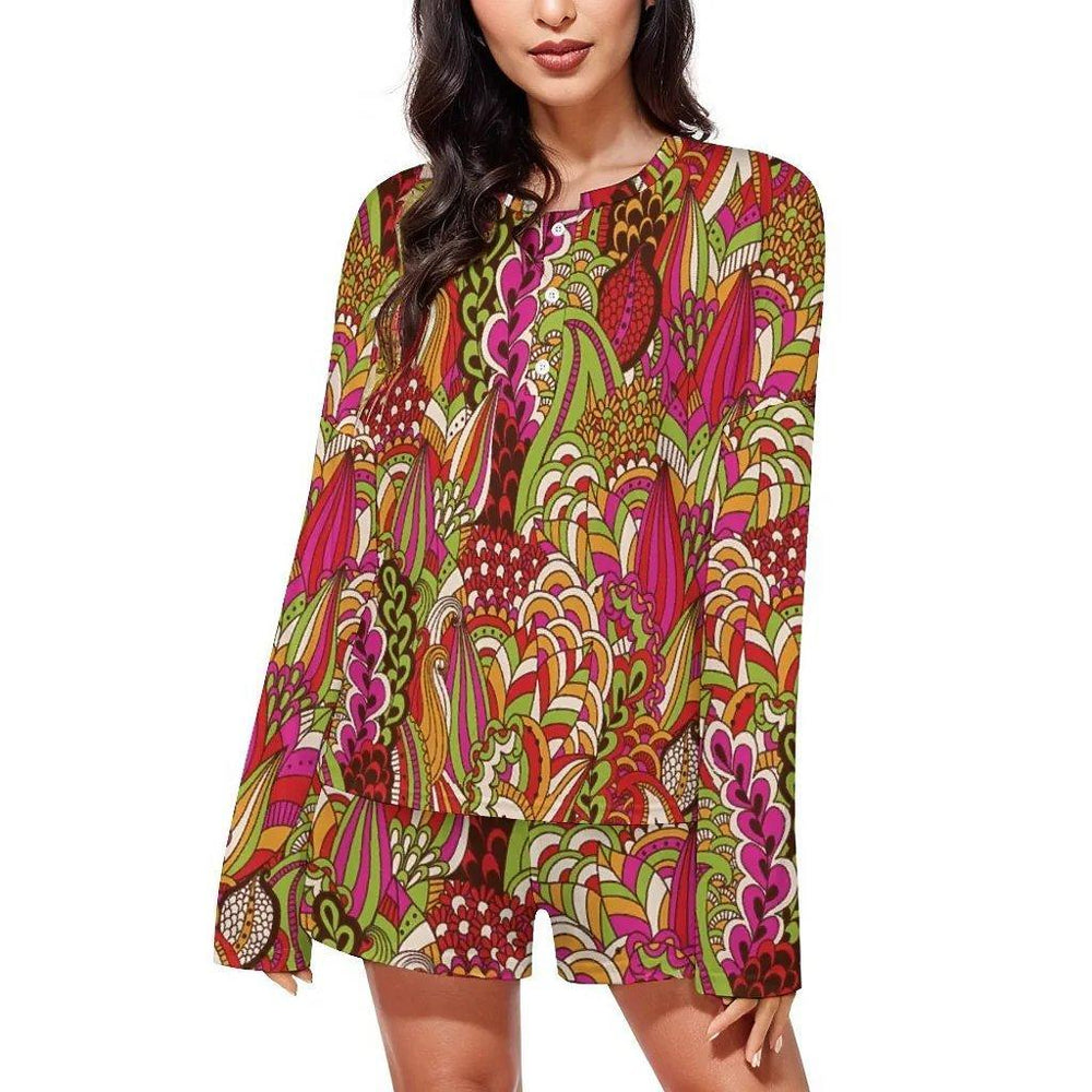 Colorful boho-chic women's pajama set with long-sleeved top and shorts featuring vibrant abstract floral pattern in red, pink, green, and orange