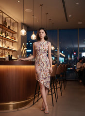 Amai dress by Blissfully Brand featuring asymmetrical hemline and vibrant abstract floral-inspired patterns.