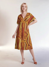Ame dress by Blissfully Brand - vibrant orange and yellow ethnic print midi dress with V-neck.
