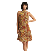 sleeveless dress with a vibrant psychedelic pattern in shades of yellow, orange, and brown. The dress has a halter neckline and an A-line silhouette. Blissfully Brand