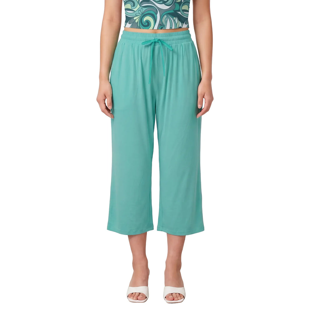 Woman wearing Puerto Rico Green wide-leg capri pants with Persian Green drawstring tie and Mima print tube top - Blissfully Brand Solid Series