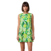 Woman wearing Misa print green paisley mini vest dress with round neckline and A-line silhouette, styled with white lace-up boots - Blissfully Brand
