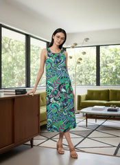 Bold and vibrant Nela dress by Blissfully Brand, featuring a retro-inspired, multicolored abstract swirl and floral pattern in greens, blues, and purples; sleeveless midi-length design perfect for making a statement for chic, retro fashion enthusiasts