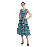 Woman wearing Nela print emerald and cobalt fit and flare midi dress with pockets, Profonde Collection by Blissfully Brand