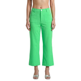 Woman wearing Nela Color Series Spring Green high-waist flared pants with Nela print sleeveless top — bold made-to-order fashion by Blissfully Brand