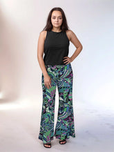 Nela Print Palazzo Pants in vibrant green, blue, and purple abstract patterns in a retro psychedelic vibe - 70's style swirls - wide leg trousers - Profonde by Blissfully Brand