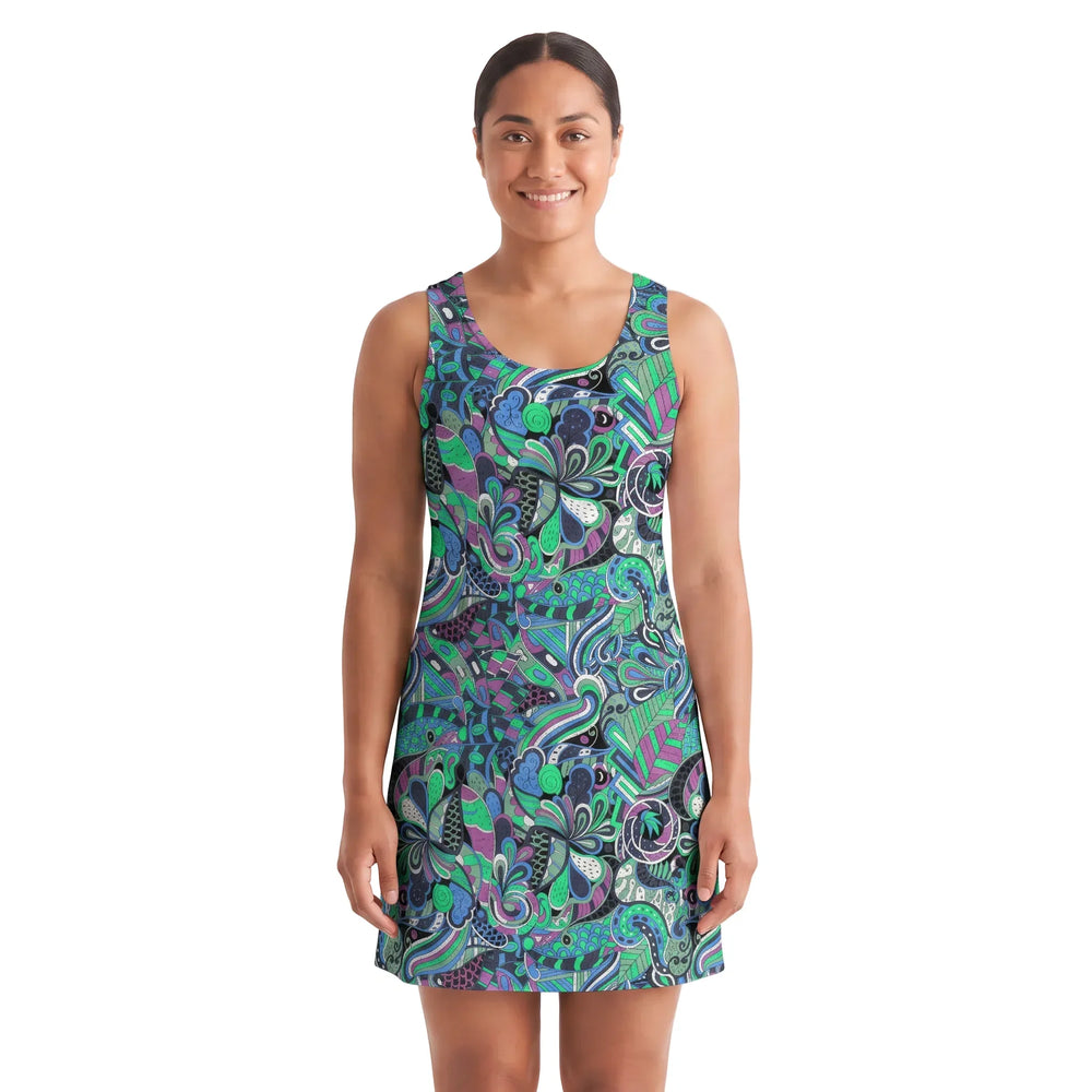 Woman wearing Nela print racerback mini dress with emerald green and cobalt blue psychedelic botanical pattern, above-knee A-line fit