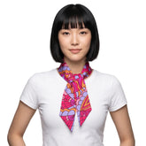 Palai retro psychedelic print silk twill ribbon scarf in hot pink, magenta, orange and lavender, worn as a neck scarf on a woman in a white tee - Blissfully Brand