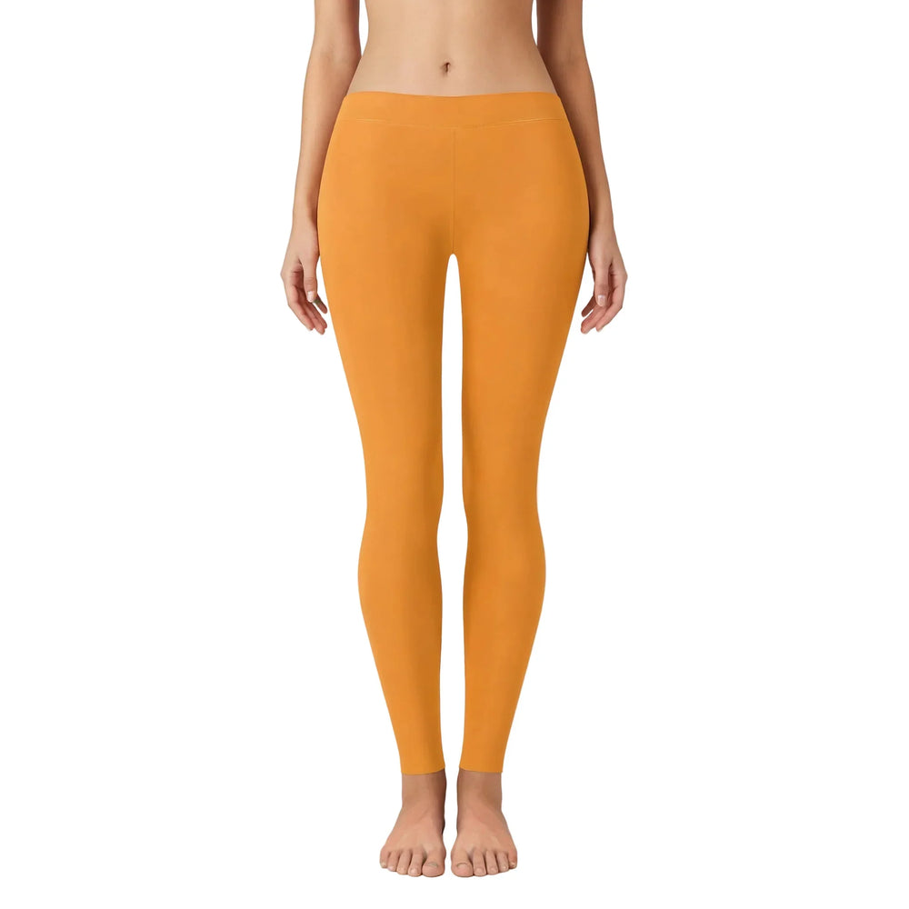 Shop our Core Series Essentials Tangerine Orange Leggings in a stunning tangerine color, featuring an elastic waistband, full-length cut, and low-waisted design. - Blissfully Brand
