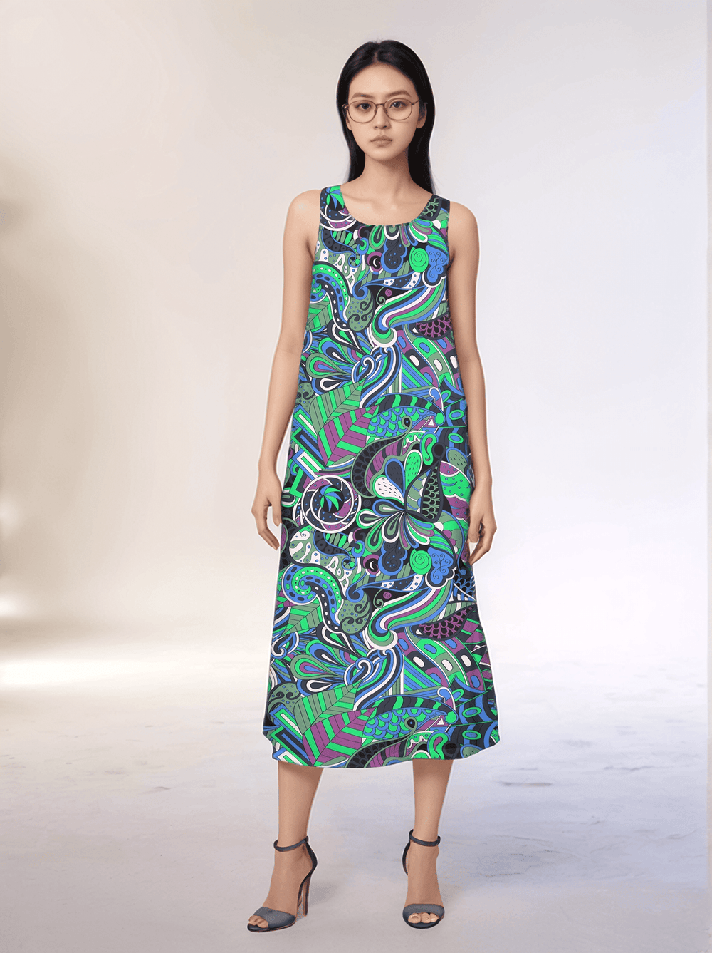 Bold and vibrant Nela dress by Blissfully Brand, featuring a retro-inspired, multicolored abstract swirl and floral pattern in greens, blues, and purples; sleeveless midi-length design perfect for making a statement for chic, retro fashion enthusiasts