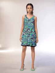 Vibrant Nela reversible dress by Blissfully Brand featuring bold, retro-inspired psychedelic patterns in green, purple, and black tones, designed in a chic, sleeveless A-line style perfect for making a statement look