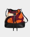 Stylish canvas bucket bag with bold abstract design, featuring a mix of vibrant red, orange, and cream geometric patterns. This chic accessory includes a sleek black base and adjustable strap