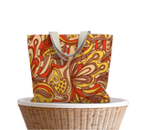 Vibrant autumn-themed tote bag with swirling abstract pattern in red, orange, yellow, and brown, paisley floral, retro psychedelic print, carry all by Blissfully Brand