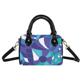 Stylish Boston Mini barrel-shaped satchel handbag with abstract geometric Kume pattern in shades of blue, purple, and teal, featuring black handles and removable shoulder strap. Retro Chic Blissfully Brand