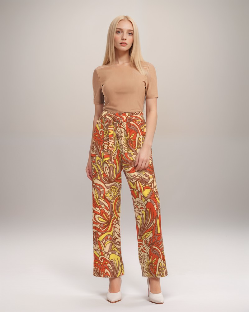 retro wide-legged pants with a vibrant orange, yellow, and brown floral  paisley psychedelic print Blissfully Brand