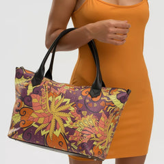 Vibrant Aki zip top large leather tote bag with psychedelic autumn leaf pattern in yellow, orange, and purple on textured Nappa leather - Blissfully Brand