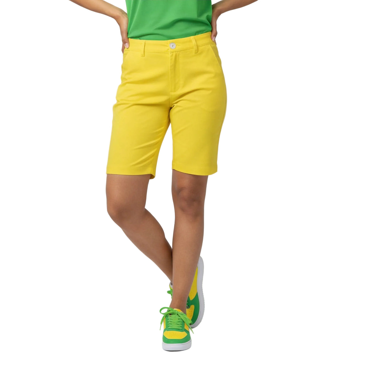 Canary Yellow Slim Fit Shorts from Core Series Essentials, paired with a green polo shirt and matching yellow-green sneakers - Blissfully Brand
