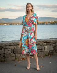 Colorful Inia print draped V-neck dress with floral swirl pattern, midi-length, and flowing silhouette - Profonde by Blissfully Brand