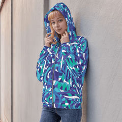 Geometric blue, teal, and purple zip-up hoodie with a bold retro Kume abstract print. The unisex hoodie features a comfortable fit and kangaroo pockets. Chic & Vibrant - Blissfully Brand