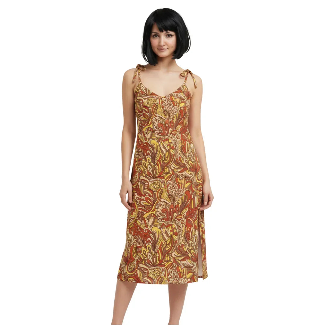 Miarna midi dress with a vibrant, psychedelic print featuring swirling patterns in shades of red, yellow, and brown. The dress has a V-neckline, spaghetti tie straps, and a leg-baring side slit. Blissfully Brand