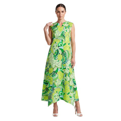 Woman wearing Misa print green botanical paisley handkerchief hem maxi dress with side pockets and white heels - Blissfully Brand