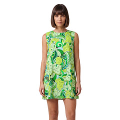 Woman wearing Misa print green paisley mini vest dress with round neckline and A-line silhouette, styled with white lace-up boots - Blissfully Brand