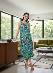 Bold and vibrant Nela dress by Blissfully Brand, featuring a retro-inspired, multicolored abstract swirl and floral pattern in greens, blues, and purples; sleeveless midi-length design perfect for making a statement for chic, retro fashion enthusiasts