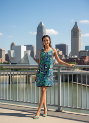 Vibrant Nela reversible dress by Blissfully Brand featuring bold, retro-inspired psychedelic patterns in green, purple, and black tones, designed in a chic, sleeveless A-line style perfect for making a statement look