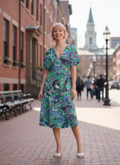 Bold and vibrant Nela dress by Blissfully Brand, featuring a retro chic design with a kaleidoscopic swirl of teal, purple, and green patterns, perfect for making a statement among bold, stylish dressers with a love for vintage-inspired flair.