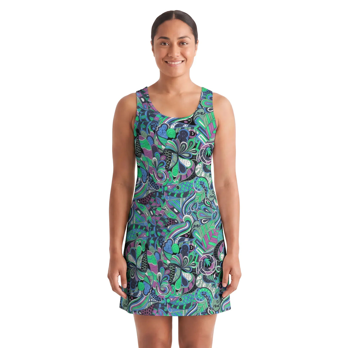 Woman wearing Nela print racerback mini dress with emerald green and cobalt blue psychedelic botanical pattern, above-knee A-line fit