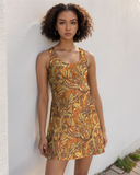 Retro-inspired  fall colors psychedelic floral sleeveless mini racerback dress with earthy orange, yellow, and brown pattern, perfect for summer fashion and casual wear