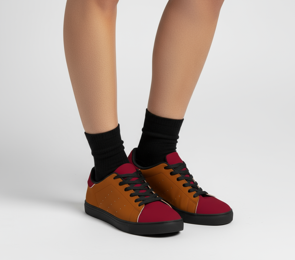  Renai women's low-top color block skater shoes featuring a warm burnt orange (Oregon Red) side panel with subtle perforations, a deep crimson (Pohutukawa Red) toe and heel tab, black laces, a black sole, - Blissfully Brand