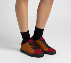  Renai women's low-top color block skater shoes featuring a warm burnt orange (Oregon Red) side panel with subtle perforations, a deep crimson (Pohutukawa Red) toe and heel tab, black laces, a black sole, - Blissfully Brand
