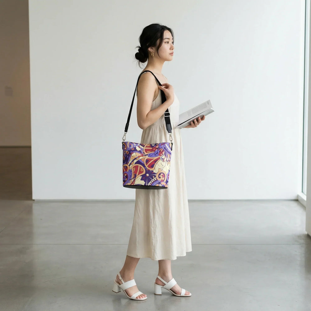 Sechie psychedelic print Nappa leather bucket bag in Blue Diamond violet, Crimson Red, and Peach Orange with nickel hardware and adjustable strap — London Bliss Collection by Blissfully Brand