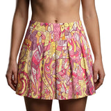 Vibrant Semia print mini pleated skirt in pink, yellow, and orange abstract patterns, featuring soft pleats for a playful, comfortable fit.