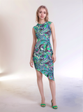 Bold retro-chic Nela dress by Blissfully Brand featuring a vibrant, asymmetrical pattern in swirling greens, purples, and blues with floral and abstract shapes, perfect for statement-makers ready to embrace vintage vibes with modern flair