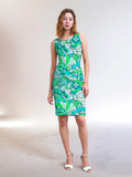 Bold retro chic sleeveless Umibe sheath dress by Blissfully Brand featuring a vibrant green, blue, and white abstract floral and swirl pattern, perfect for making a statement with its fitted silhouette and artistic 1960s-inspired design