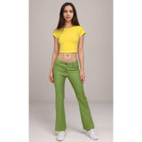 Retro women's flare pants with a vibrant shimmering green. The pants are flowy and comfortable, perfect for a bohemian look.