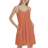 Women's sleeveless orange summer dress with green trim, featuring a V-neckline and side pockets, perfect for casual wear and beach outings