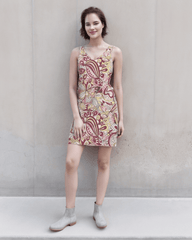 stunning sleeveless Piki rib-knit dress featuring a vibrant retro psychedelic paisley and floral print in shades of burgundy, pink, yellow, and cream. The dress is a mini length, V-neck design that flatters the figure - Blissfully Brand