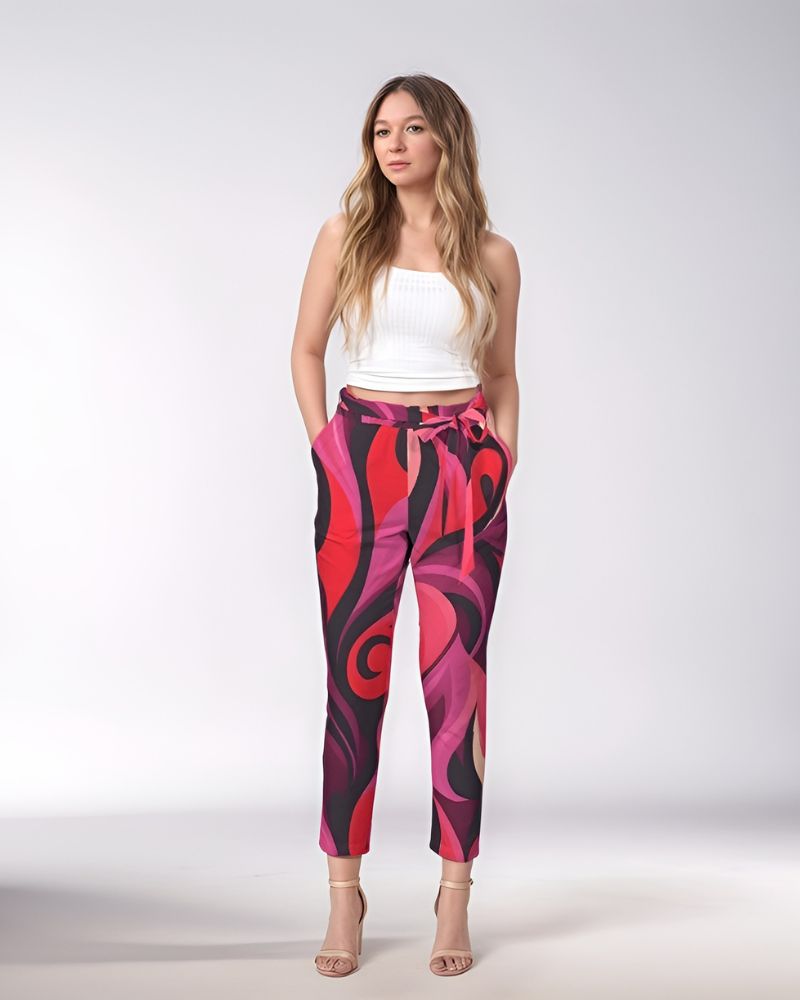 Women's high-waisted trousers with vibrant red and pink abstract swirly fire print, tie-belt, and ankle-length cut. Prague Retro Chic Airline Series - Blissfully Brand